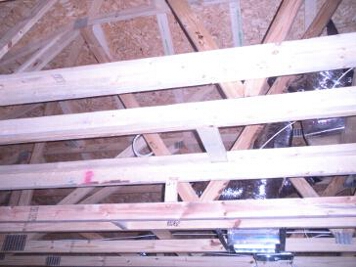 Surround speaker cables run above the rafters to the rear speakers before insulation is blown in